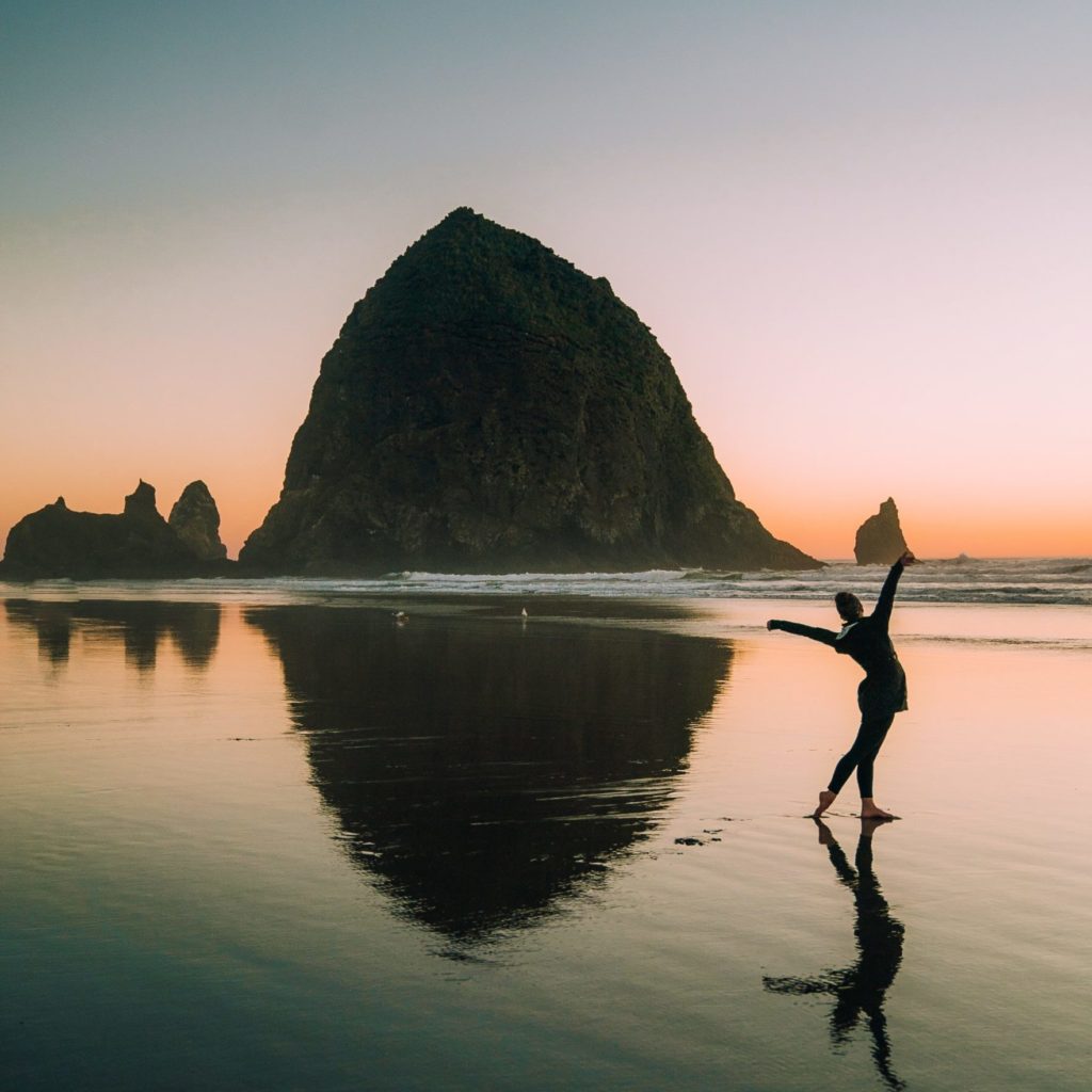 Person on beach in Oregon at sunset