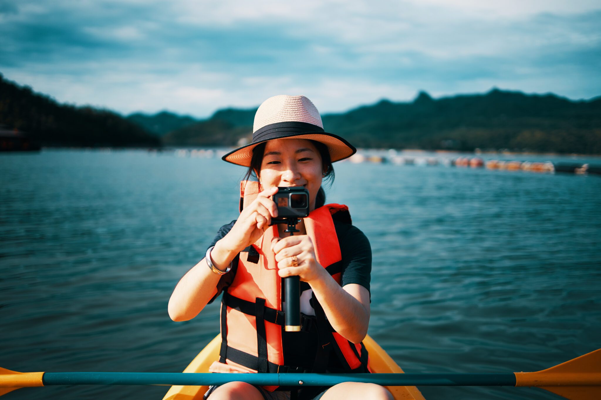 woman kayaking taking photo